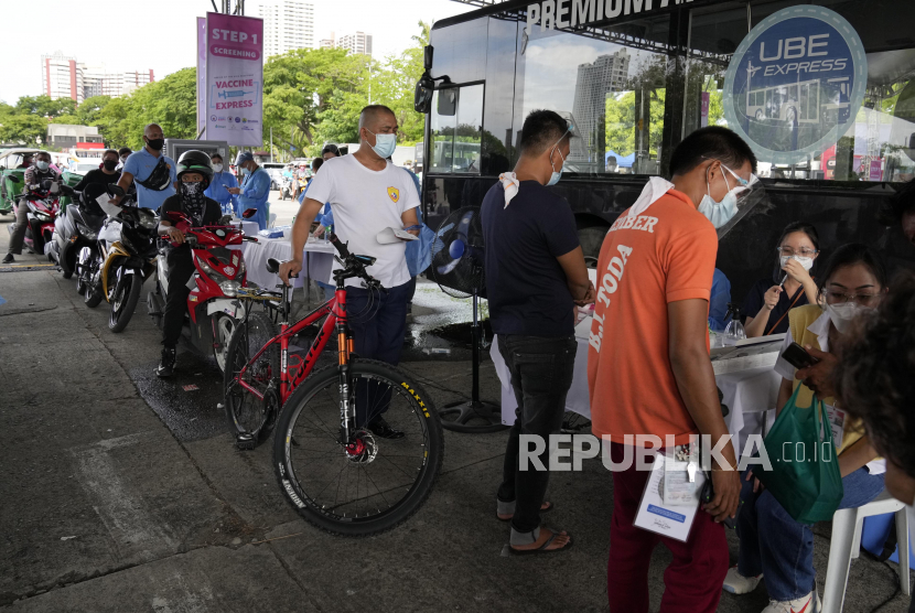 Pesepeda mengantre untuk disuntik Vaksin Covid-19 Sinovac di pusat vaksinasi drive thru, Manila, Filipina, Selasa (22/6).