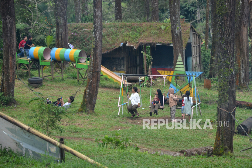 Pengunjung bermain di kawasan hutan pinus Cikole, Kecamatan Lembang, Kabupaten Bandung Barat