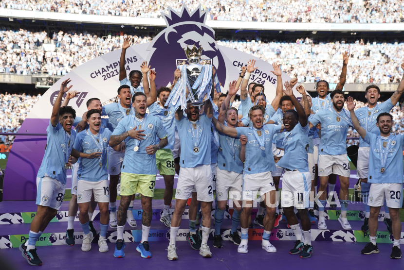 Manchester City players celebrate with the Premier League trophy after the English Premier League soccer match between Manchester City and West Ham United at the Etihad Stadium in Manchester, England, Sunday, May 19, 2024. Manchester City clinched the English Premier League on Sunday after beating West Ham in their last match of the season.  