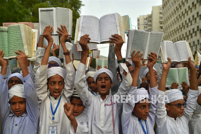 Siswa sekolah Islam Pakistan mengangkat Alquran di jalan saat demonstrasi menentang Swedia di Karachi, Pakistan, (6/7/2023).  