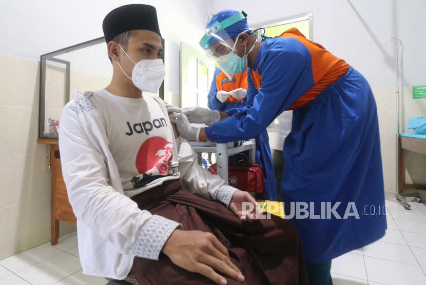 Petugas kesehatan menyuntikkan vaksin Covid-19 kepada pengasuh pondok pesantren (ponpes) Lirboyo di Kota Kediri, Jawa Timur, Jumat (26/2).