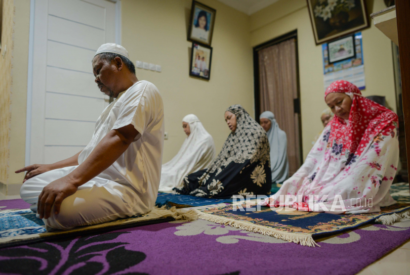 Syarat Menjadi Imam Sholat. Seorang warga melaksanakan shalat tarawih di rumah bersama keluarga.