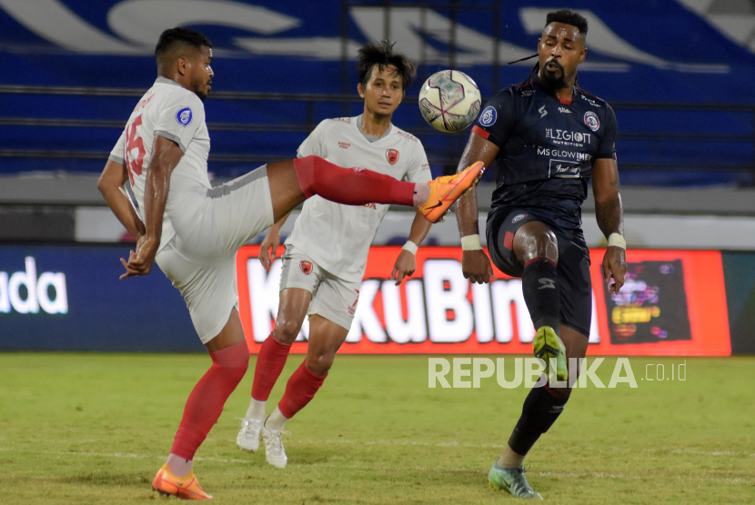 Pesepak bola Arema FC Carlos Fortes (kanan) berebut bola dengan pesepak bola PSM Makassar Hasim Kipuw (kiri) pada pertandingan Liga 1 di Stadion Kapten I Wayan Dipta, Gianyar, Bali, Rabu (30/3/2022). Arema FC menang atas PSM Makassar dengan skor 1-0. 