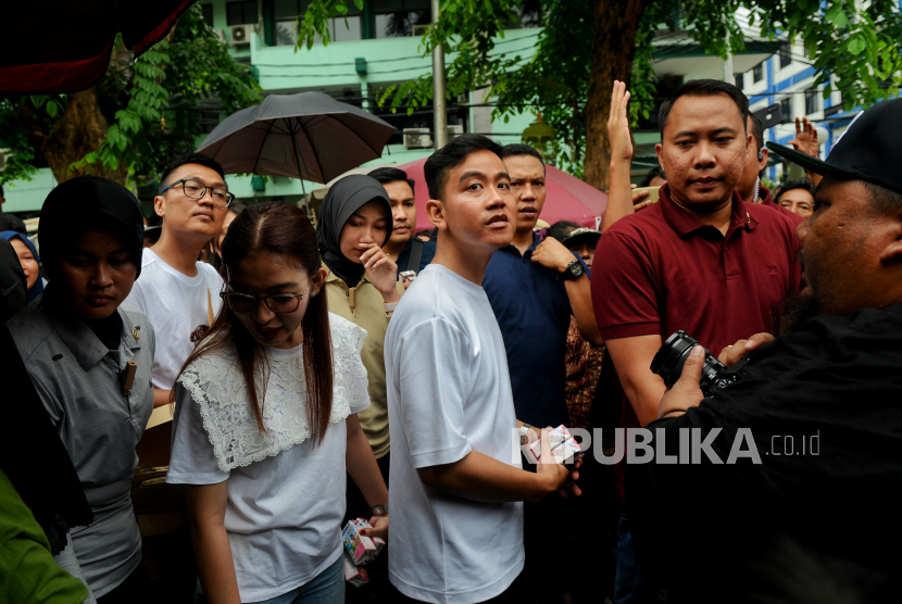 Cawapres nomor urut dua Gibran Rakabuming Raka didampingi istrinya Selvi Ananda saat berkampanye mengunjungi Pasar Rawasari, Cempaka Putih, Jakarta Pusat, Ahad (3/12/2023). 