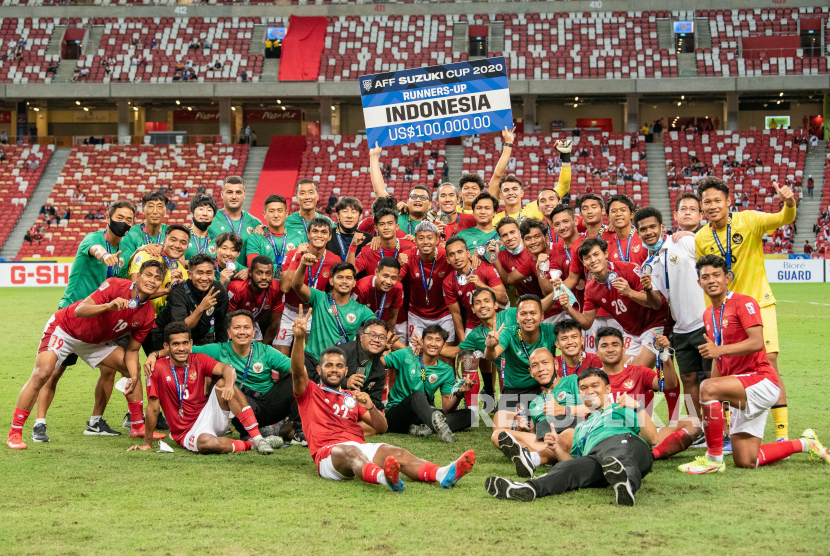 Sejumlah pesepak bola dan tim pelatih timnas Indonesia berfoto bersama usai pengalungan medali Piala AFF 2020 di National Stadium, Singapura, Sabtu (1/1/2022). Indonesia menduduki juara kedua usai seri melawan timnas Thailand dengan skor 2-2 atau kalah agregat 2-6. 