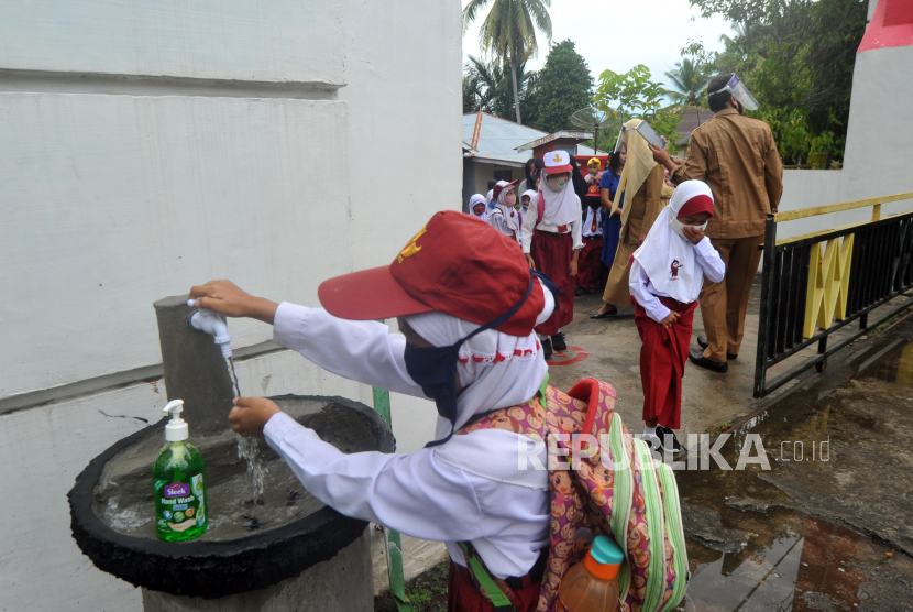 Sejumlah murid mencuci tangan sebelum masuk hari pertama sekolah di SDN 11 Marunggi Pariaman, Sumatera Barat, Senin (13/7/2020). Pada Kamis (23/7), kasus positif covid-19 di Provinsi Sumatera Barat mengalami penambahan sebanyak 3 orang. Total kasus covid-19 di Sumbar sudah 849 orang. 