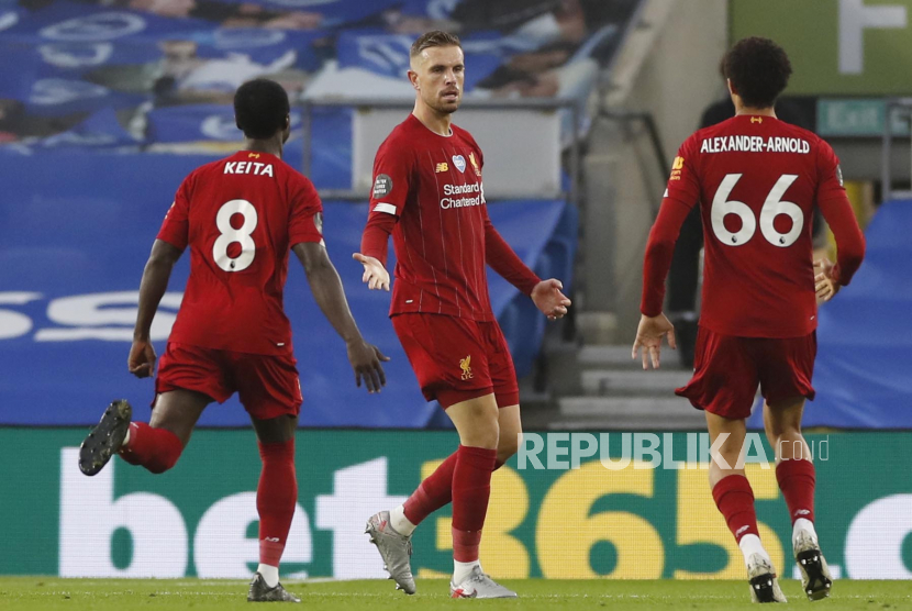 Kapten Liverpool Jordan Henderson (tengah) merayakan golnya ke gawang Brighton & Hove Albion. Henderson mengalami cedera pada laga ini.
