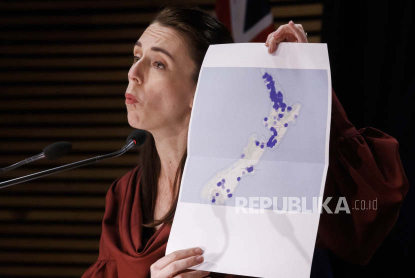 Perdana Menteri Selandia Baru Jacinda Ardern memegang peta Selandia Baru selama konferensi pers pembaruan COVID-19 di Wellington, Selandia Baru, Senin, 23 Agustus 2021. 
