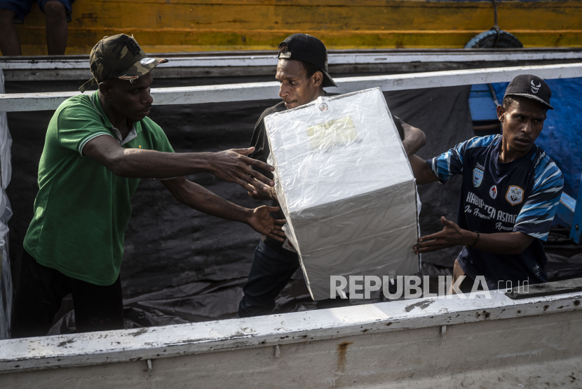 Tiga relawan memindahkan logistik Pemilu 2024 ke atas kapal di dermaga feri Distrik Agats, Kabupaten Asmat, Papua Selatan, Ahad (11/2/2024). Komisi Pemilihan Umum (KPU) Kabupaten Asmat menetapkan daftar pemilih tetap (DPT) Kabupaten Asmat sebanyak 80.122 orang yang tersebar di 224 kampung dengan 352 tempat pemungutan suara (TPS). 