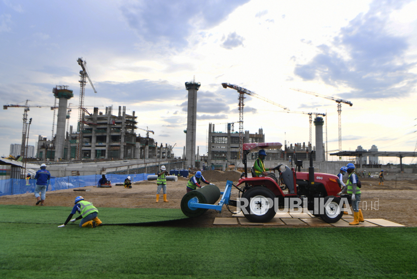 Pekerja menyelesaikan pemasangan rumput untuk lapangan latih di Kompleks Stadion Utama Jakarta International Stadium (JIS), Jakarta, Jumat (23/10/2020). Sebanyak dua lapangan latih JIS mulai dipasang rumput hibrid berstandar internasional pertama di Indonesia yang ditargetkan selesai pengerjaannya pada Desember 2020 
