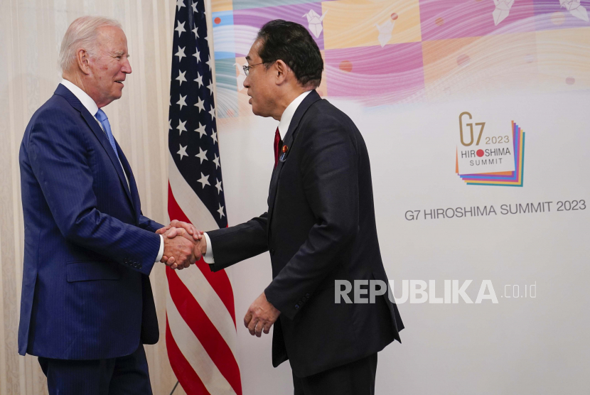 Presiden AS Joe Biden (kiri) berjabat tangan dengan Perdana Menteri Jepang Fumio Kishida sebelum melakukan pertemuan bilateral di Hiroshima, Jepang, Kamis (18/5/2023) menjelang pembukaan KTT G-7. 