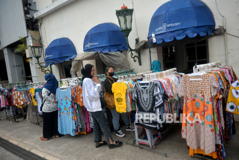 Pedagang melayani pembeli cenderamata di Malioboro, Yogyakarta, Selasa (25/1/2022). Gubernur DIY Sultan HB X memastikan  pemindahan pedagang kaki Lima (PKL) Malioboro akan dilakukan pada Rabu (26/1/2022) sebagai permulaan. Menurutnya proses pemindahan itu akan berlangsung antara dua hingga tiga pekan ke depan.