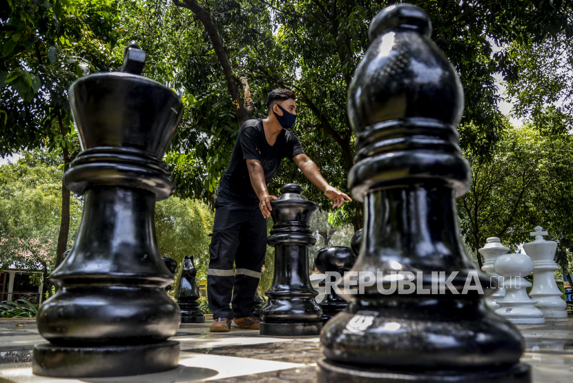 Sejumlah petugas saat bermain catur di Taman Danau Singkarak yang masih dalam masa penutupan di kawasan Bendungan Hilir, Jakarta, Selasa (8/9). Permainan catur berukuran besar itu menjadi fasilitas permainan baru bagi pengunjung taman tersebut. Republika/Putra M. Akbar