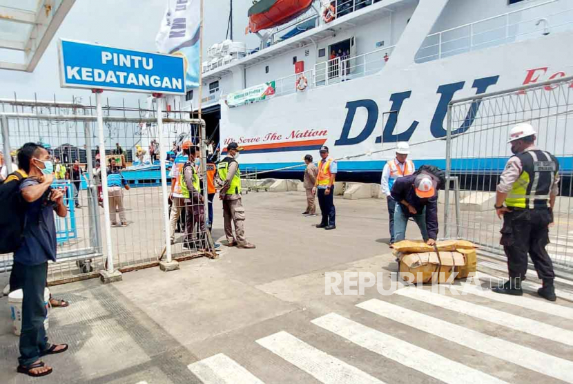 Petugas gabungan di Terminal Penumpang Pelabuhan tanjung Emas Semarang menyambut kedatangan para pemudik yang baru turun dari Kapal Motor (KM) Dharma Ferry 2 di dermaga Terminal Penumpang Pelabuhan Tanjung Emas Semarang, Jawa Tengah, Senin (10/4).