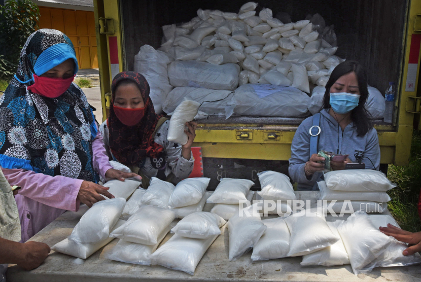 Petugas melayani warga yang membeli gula pasir saat digelar operasi pasar (ilustrasi)