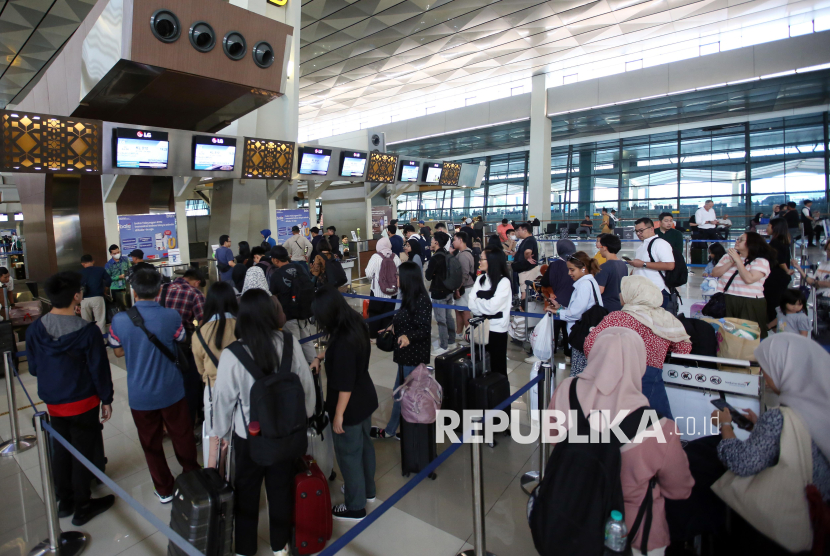 Sejumlah penumpang antre melakukan lapor diri di konter chek in Terminal 3 Bandara Soekarno Hatta, Tangerang, Banten, Senin (16/12/2024). Sepekan menjelang perayaan hari Natal dan juga libur akhir tahun, sejumlah warga sudah melakukan perjalan mudik dan liburan dengan pesawat terbang lebih awal untuk menghindari padatnya penumpang sehingga sulit mendapatkan kursi pesawat. 