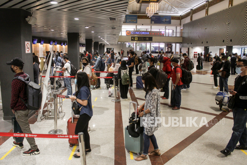 Calon penumpang mengantre di loket check in Bandara Juanda, di Kabupaten Sidoarjo, Jawa Timur, Kamis (24/12/2020). 