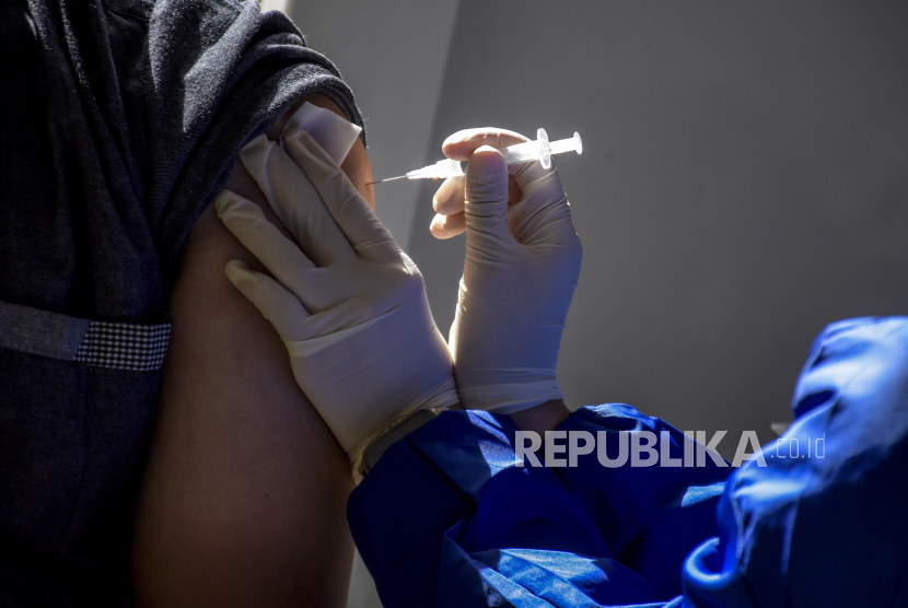 Vaksinator menyuntikkan vaksin Covid-19 booster ke warga saat pelaksanaan vaksinasi Covid-19 massal di Taman Dewi Sartika, Jalan Wastukencana, Kota Bandung, Jumat (8/4/2022). Satgas Covid-19 Kota Bandung mencatat jumlah kasus aktif terus mengalami penurunan.