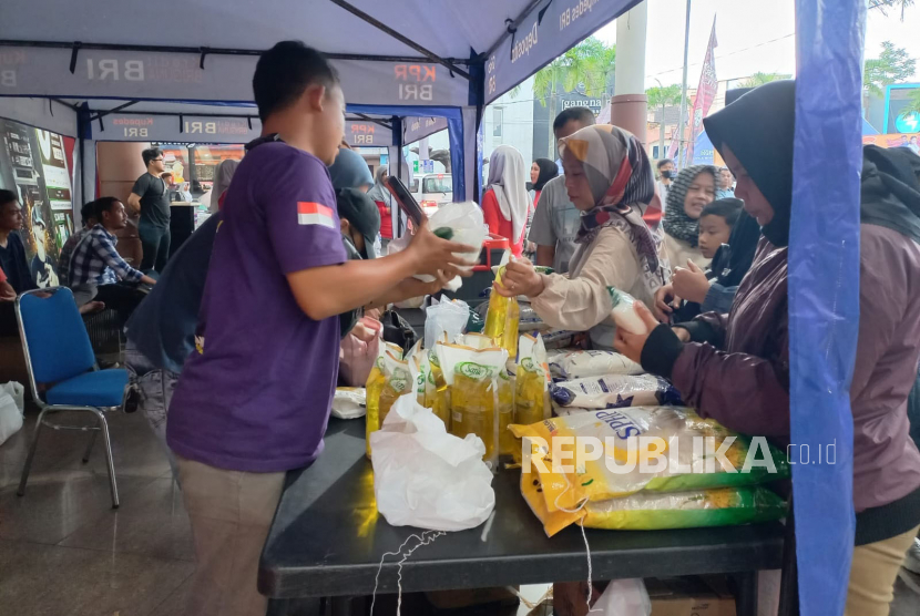 Sejumlah warga membeli bahan kebutuhan pokok saat kegiatan pasar murah yang digelar Polres Tasikmalaya Kota di Plaza Asia, Kota Tasikmalaya, Jawa Barat, Sabtu (1/7/2023).