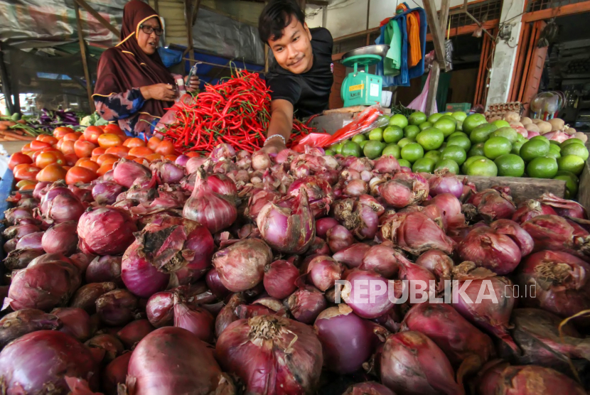 Pedagang melayani pembeli bawang merah di pasar tradisional Kota Lhokseumawe, Aceh. Cuaca ekstrem yang silih berganti beberapa waktu terakhir turut berdampak pada penurunan produksi bawang merah nasional. Dampak berupa kenaikan harga signifikan hingga ke tangan konsumen tidak terbendung. Di sisi lain, permintaan bawang merah tengah mengalami lonjakan karena aktivitas pemulihan ekonomi.