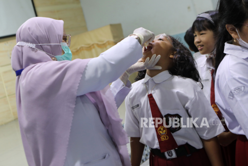 Petugas Puskesmas melakukan vaksinasi polio tahap kedua menggunakan vaksin polio oral bivalen (BOPV) untuk anak-anak di sekolah lokal di Banda Aceh, Senin (13/2/2023). Pemerintah Aceh melanjutkan vaksinasi polio tahap kedua untuk sekolah anak di Aceh sebagai upaya membebaskan Aceh dari kasus polio, menyusul ditemukannya kasus polio di Aceh pada tahun 2022.blic Health Center staff conduct the second phase of polio vaccination using a bivalent oral polio vaccine (BOPV) for children at a local school in Banda Aceh, Indonesia, 13 February 2023. The local government of Aceh continue the second phase of polio vaccination for school children in Aceh as an effort to free Aceh from polio cases, following the discovery of polio cases in Aceh in 2022.  