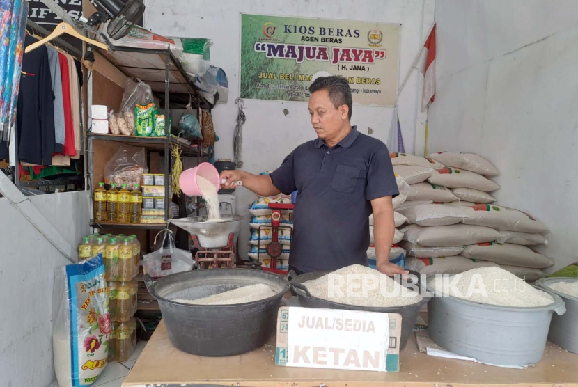 Seorang pedagang beras di Pasar Mambo Indramayu sedang menimbang beras, Jumat (23/2/2024). Harga beras kembali naik, baik kualitas premium maupun medium. 