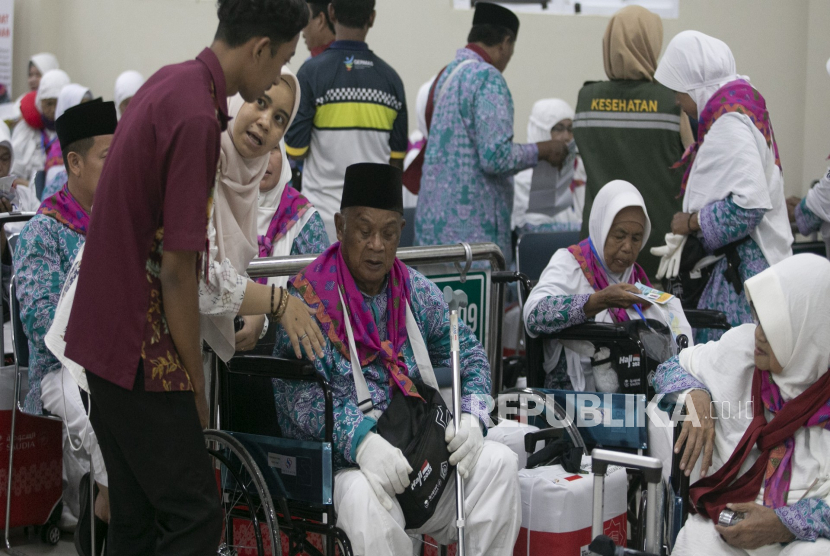 Petugas membantu jamaah calon haji saat memasuki Asrama Haji Embarkasi Kertajati, Indramayu, Jawa Barat, Sabtu (27/5/2023) malam. 