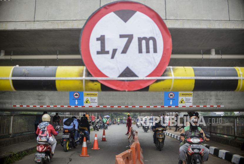 Sejumlah pengendara motor melintas di bawah box girder proyek Kereta Cepat Jakarta-Bandung yang berada di atas Jembatan Antelope di Curug, Kota Bekasi, Jawa Barat, Rabu (15/6/2022). 