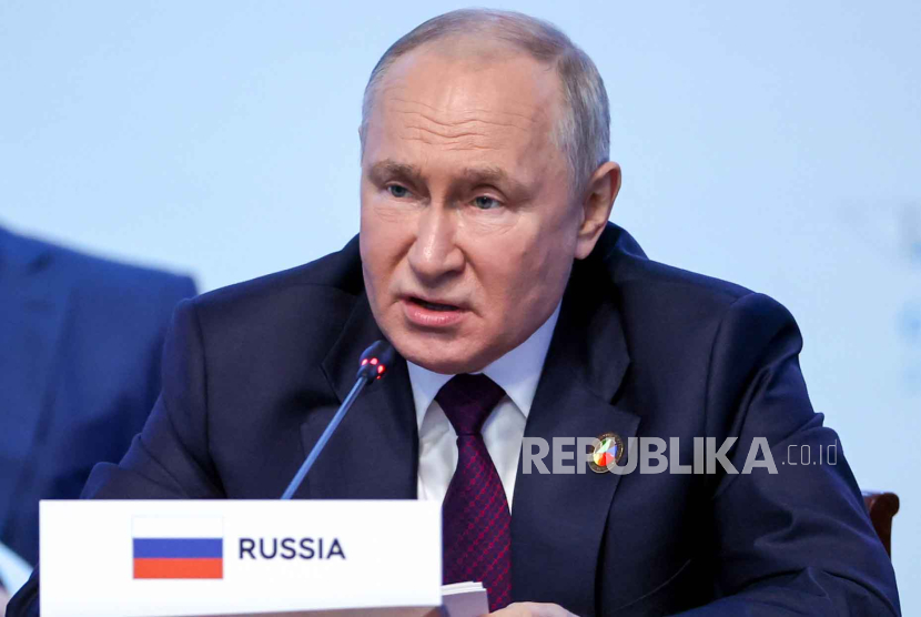 A handout photo made available by TASS Host Photo Agency shows Russian President Vladimir Putin addressing a plenary session during the Second Summit 