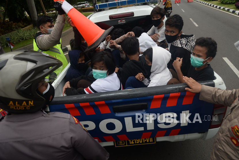 Petugas kepolisian mengamankan sejumlah pelajar yang diduga hendak mengikuti aksi di Kawasan Senayan, Jakarta, Kamis (8/10). Puluhan pelajar tersebut diduga terhasut ajakan aksi demo menolak UU Cipta kerja.Prayogi/Republika