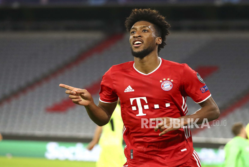 Bayern Munichs Kingsley Coman celebrates after scoring his teams fourth goal during the Champions League Group A soccer match between Bayern Munich and Atletico Madrid at the Allianz Arena in Munich, Germany, Wednesday, Oct. 21, 2020. (AP Photo/Matthias Schrader,Pool)