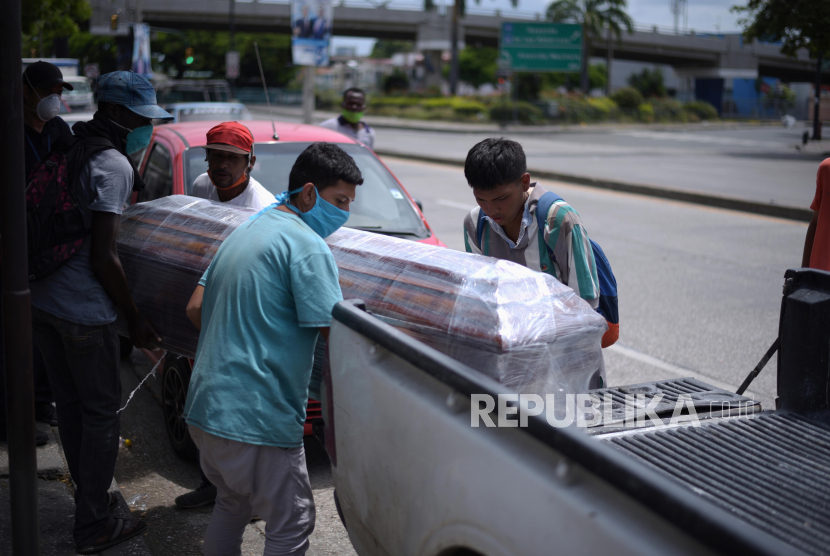 Penyedia jasa pengangkut peti jenazah membawa peti korban COVID-19 di pemakaman kota, di Guayaquil, Ekuador Ahad (12/4). Pribumi Ekuador sandera polisi tuntut kembalikan jenazah pemimpin mereka yang meninggal karena Covid-19. Ilustrasi.