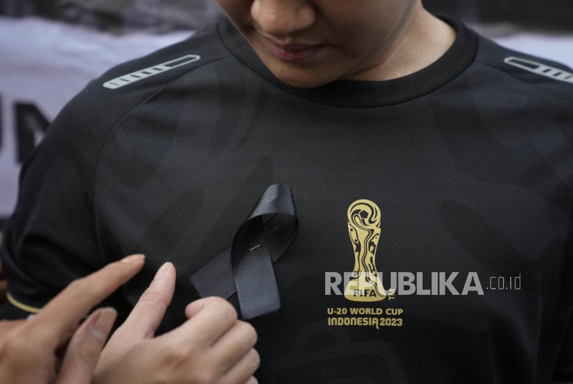  Seorang aktivis memasang pita hitam di dadanya saat unjuk rasa menentang pembatalan Piala Dunia FIFA U-20, di Jakarta, Indonesia, Jumat (31/3/2023).
