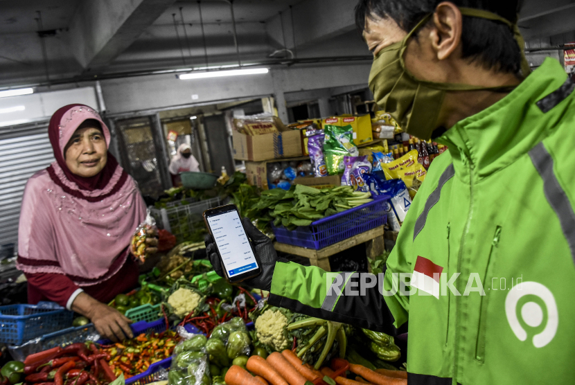 Pedagang melayani pesanan belanja daring di Pasar Kosambi, Kota Bandung, Ahad (12/4). Transaksi belanja ritel secara daring meningkat enam kali lipat  selama pandemi Covid-19.