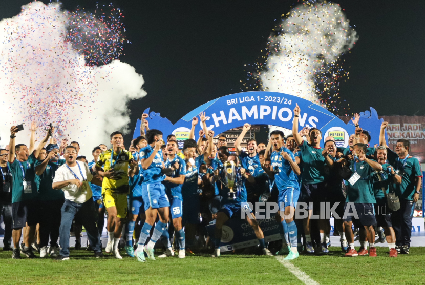Pesepak bola Persib Bandung dan ofisial tim mengangkat piala usai menjadi juara BRI Liga 1 2023/2024 di Stadion Gelora Bangkalan, Bangkalan, Jawa Timur, Jumat (31/5/2024). Persib Bandung mengalahkan Madura United dengan agregat gol 6-1.