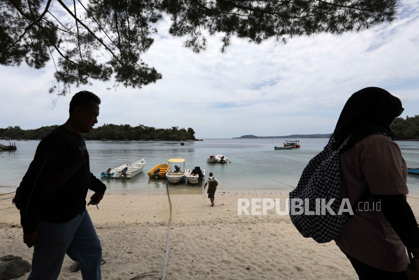 Foto siluet wisatawan berjalan di pantai Pulau Weh, Sabang, Aceh, Selasa (12/9/2023).