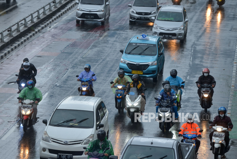 Pengendara motor dengan mengunakan mantel menerjang hujan di Jalan  Gatot Subroto, Jakarta. Prediksi badai disampaikan secara pribadi oleh peneliti BRIN lewat media sosial. Ilustrasi.