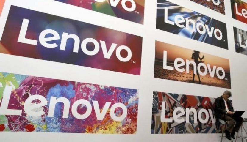 A man uses his laptop next to Lenovo's logos during the Mobile World Congress in Barcelona, Spain February 25, 2016. (REUTERS/Albert Gea)