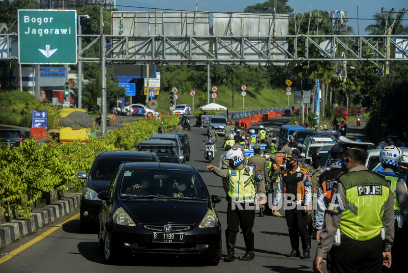 Kerahkan TNI, Pembukaan Jalur Puncak Dua Jalan Terus. Sejumlah petugas gabungan saat memutarbalikan pengendara yang akan menuju kawasan Puncak, Bogor, Jawa Barat.