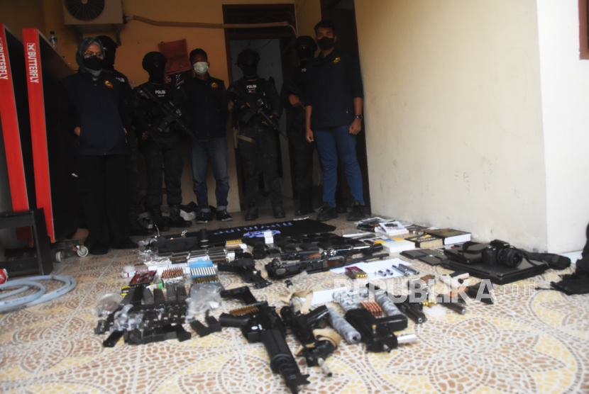 Sejumlah anggota Densus  88 menunjukkan barang bukti senjata api dan barang bukti lainnya milik terduga teroris berinisial DE yang ditangkap di Bekasi, Jawa Barat, Senin (14/8/2023). 