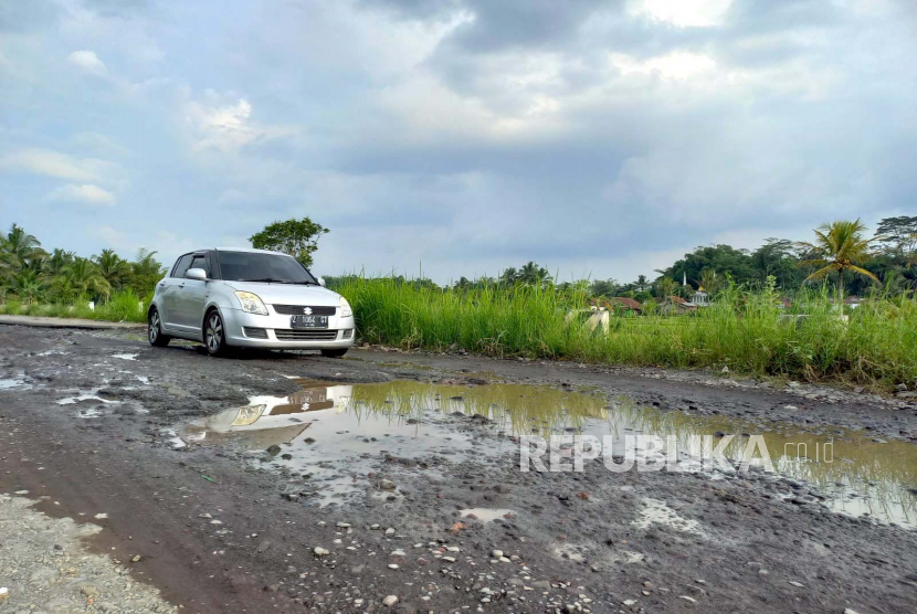 Pengguna kendaraan melintasi jalan yang kondisinya rusak di ruas Jalan Cipanas Galunggung, Desa Gunungsari, Kecamatan Sukaratu, Kabupaten Tasikmalaya, Jawa Barat, Rabu (10/5/2023). 