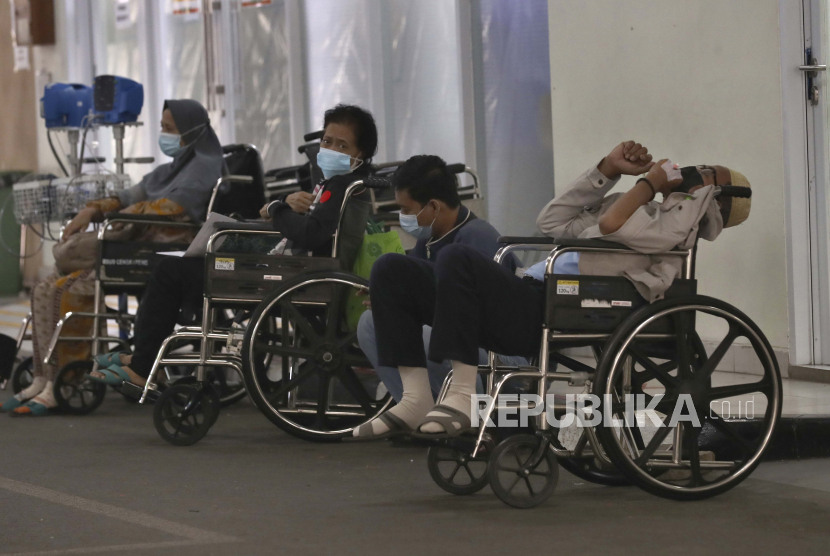 Orang-orang menunggu perawatan medis di luar ruang gawat darurat. Untuk membantu mobilisasi pasien, terutama pasien kritis, mobil patroli Suku Dinas Perhubungan (Sudinhub) Jakarta Barat akan digunakan untuk membawa pasien kritis ke rumah sakit.