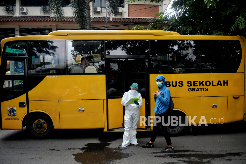 Pasien Covid-19 menaiki bus untuk di evakuasi di Puskesmas Kecamatan Setiabudi, Jakarta, Rabu (9/2/2022). Sebanyak 13 warga yang terinfeksi Covid-19 dievakuasi menuju Rumah Sakit Darurat Covid-19 (RSDC) Wisma Atlet Kemayoran untuk menjalani perawatan. Republika/Thoudy Badai