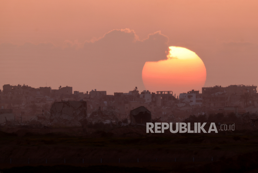 The sun sets over Gaza, amid the ongoing conflict between Israel and the Palestinian Islamist group Hamas, as seen from Israel