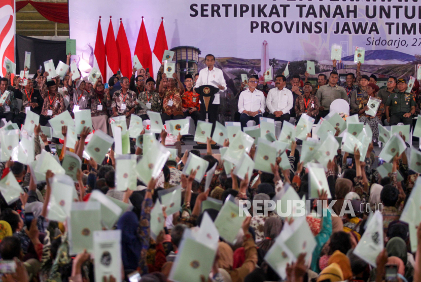 Presiden Joko Widodo menghitung sertifikat tanah warga saat penyerahan  sertifikat tanah untuk rakyat Jawa Timur di Gelora Delta Sidoarjo, Jawa Timur, Rabu (27/12/2023).