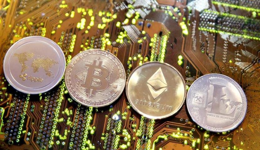 Representations of the Ripple, Bitcoin, Etherum and Litecoin virtual currencies are seen on a PC motherboard in this illustration picture, February 13, 2018. (Reuters/Dado Ruvic)