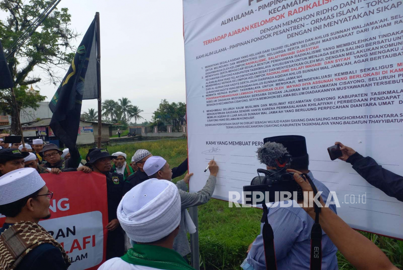 Sejumlah warga melakukan aksi di Desa Sukaraharja, Kecamatan Cisayong, Kabupaten Tasikmalaya, Jumat (3/2/2023). Massa aksi meminta Pemkab Tasikmalaya meninjau ulang perizinan pembangunan pesantren baru di lokasi itu. 