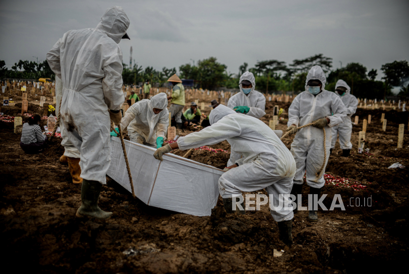 Petugas menurunkan peti jenazah pasienCovid-19  di TPU khusus Covid-19 Rorotan, Jakarta Utara, Selasa (13/7). Pada Agustus, angka kematian Covid-19 di Jakarta mulai mengalami penurunan. (ilustrasi)