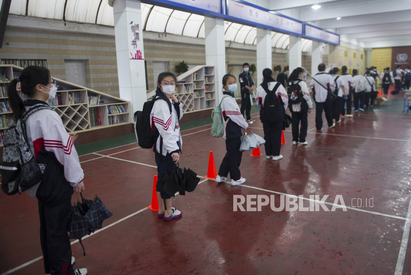 Siswa kelas sembilan mengikuti tes wajib virus corona di sebuah sekolah di Wuhan, Provinsi Hubei, Cina, Kamis (14/5). Imbas adanya pasien virus crona baru, pemerintah berencana untuk menguji semua warga negara