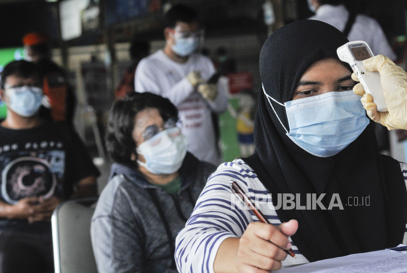 Petugas mengukur suhu tubuh calon penumpang KRL (Kereta Rel Listrik) yang akan melakukan tes usap antigen di Stasiun Bekasi, Jawa Barat (ilustrasi)